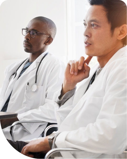 Two doctors listening to someone speaking