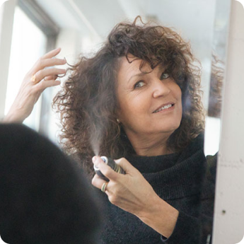 woman spraying hair