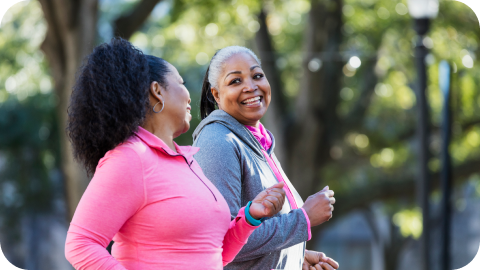 Two women in workout clothes exercising